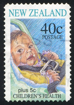 NEW ZEALAND - CIRCA 1996: stamp printed by New Zealand, shows Infant Buckled into Child Safety Seat, circa 1996のeditorial素材
