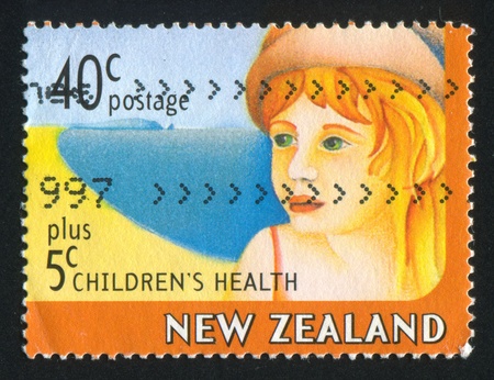 NEW ZEALAND - CIRCA 1997: stamp printed by New Zealand, shows Child on Beach, circa 1997のeditorial素材