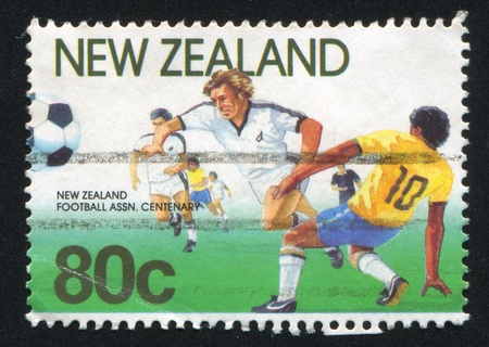 NEW ZEALAND - CIRCA 1991: stamp printed by New Zealand, shows Football Players, circa 1991のeditorial素材