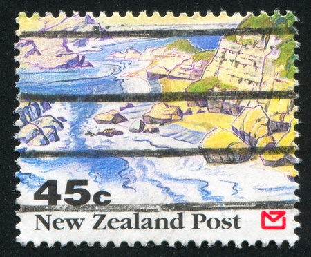NEW ZEALAND - CIRCA 1992: stamp printed by New Zealand, shows Scenic Views of New Zealand, Rocky shoreline, circa 1992の写真素材