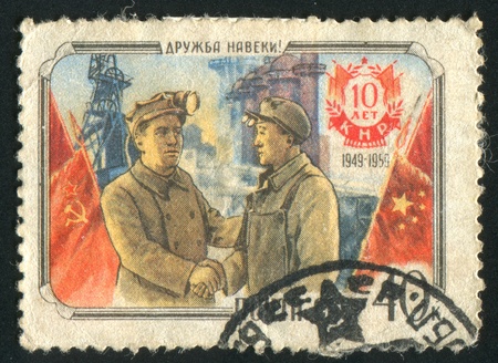RUSSIA - CIRCA 1959: stamp printed by Russia, shows Russian miner and Chinese steel worker, circa...