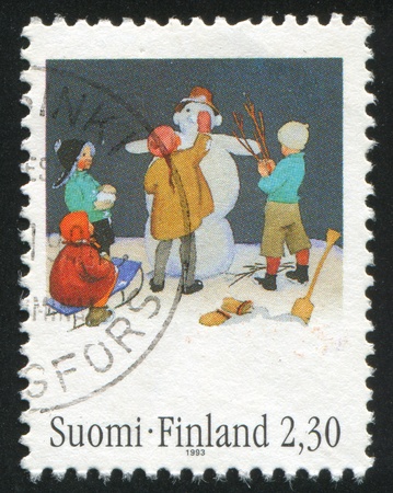 FINLAND - CIRCA 1993:  stamp printed by Finland, shows children in make snowman, circa 1993の写真素材