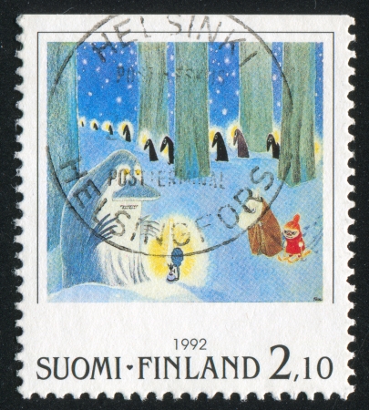FINLAND - CIRCA 1992: stamp printed by Finland, shows Moomin characters in winter forest, circa 1992の写真素材