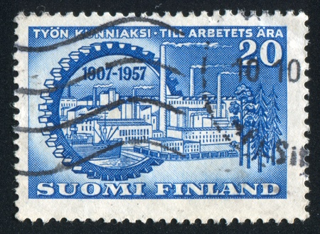 FINLAND - CIRCA 1957: stamp printed by Finland, shows Industrial City inside Cog, circa 1957の写真素材