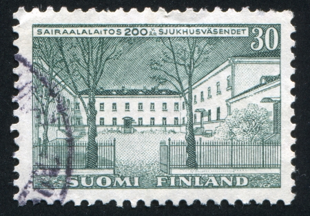 FINLAND - CIRCA 1956: stamp printed by Finland, shows Helsinki University Clinic, circa 1956の写真素材