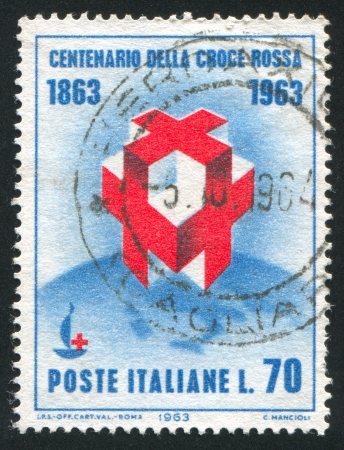 ITALY - CIRCA 1963: stamp printed by Italy, shows Crosses and Centenary Emblem on Globe, circa 1963のeditorial素材