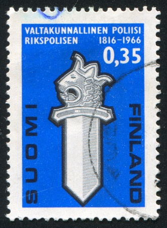 FINLAND - CIRCA 1966:  stamp printed by Finland, shows lions head and sword, circa 1966の写真素材