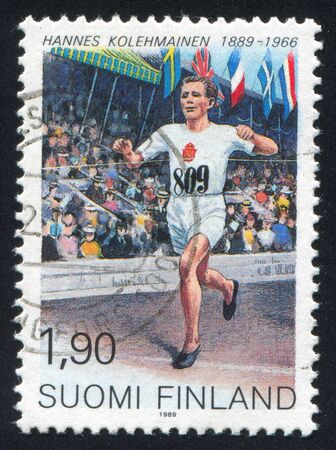 FINLAND - CIRCA 1989: stamp printed by Finland, shows Long Distance Runner Hannes Kolehmainen, circa 1989のeditorial素材