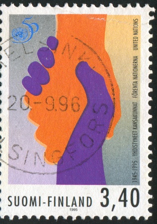 FINLAND - CIRCA 1995: stamp printed by Finland, shows Handshake, circa 1995の写真素材