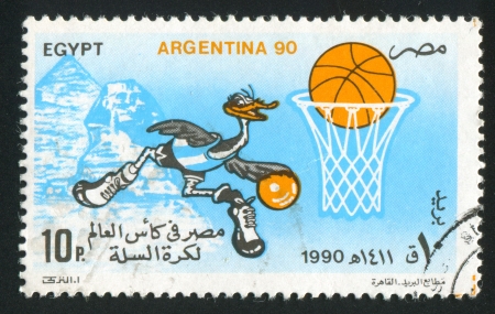 EGYPT - CIRCA 1990: stamp printed by Egypt, shows Basketball championship mascot, ball, Sphinx, Pyramid, circa 1990のeditorial素材