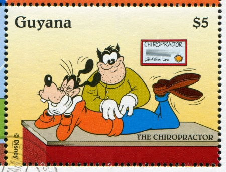 GUYANA - CIRCA 1995: stamp printed by Guyana, shows Walt Disney characters, Goofy, Chiropractor, circa 1995のeditorial素材
