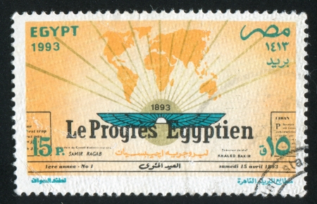 EGYPT - CIRCA 1993: stamp printed by Egypt, shows World map, wings, rays, inscription, circa 1993のeditorial素材