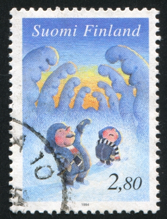 FINLAND - CIRCA 1994: stamp printed by Finland, shows Father and Son Looking for Christmas Tree, circa 1994のeditorial素材