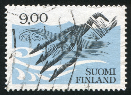 FINLAND - CIRCA 1984: stamp printed by Finland, shows Four-toothed Fishing Spear, circa 1984のeditorial素材