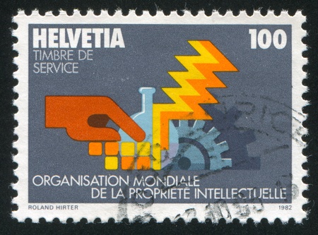 SWITZERLAND - CIRCA 1982: stamp printed by Switzerland, shows Industrial symbols, circa 1982のeditorial素材