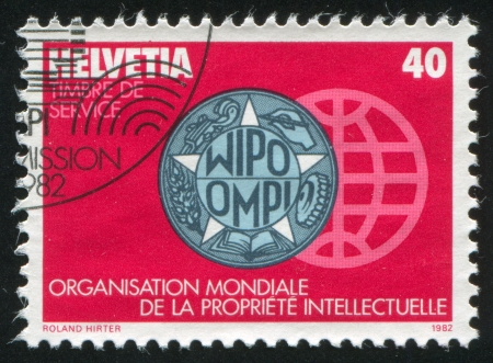 SWITZERLAND - CIRCA 1982: stamp printed by Switzerland, shows WIPO Emblem, circa 1982のeditorial素材