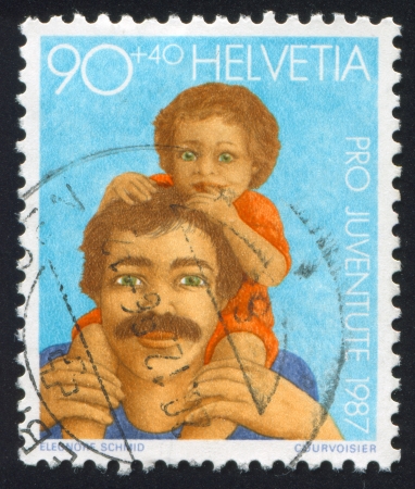 SWITZERLAND - CIRCA 1987: stamp printed by Switzerland, shows  Father, Child, circa 1987のeditorial素材