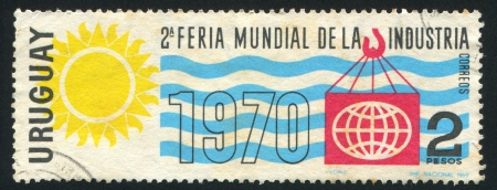 URUGUAY - CIRCA 1969: stamp printed by Uruguay, shows Industrial World Fair Emblem, circa 1969のeditorial素材