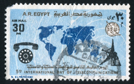 EGYPT - CIRCA 1973: stamp printed by Egypt, shows World map, radar, phone, circa 1973のeditorial素材