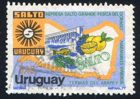 URUGUAY - CIRCA 1977: stamp printed by Uruguay, shows Coat of Arms and Map of Salto Department, circa 1977のeditorial素材