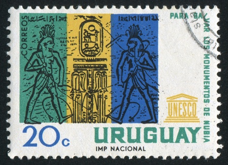 URUGUAY - CIRCA 1964: stamp printed by Uruguay, shows Nile Gods Uniting Upper and Lower Egypt (Abu Simbel), circa 1964のeditorial素材