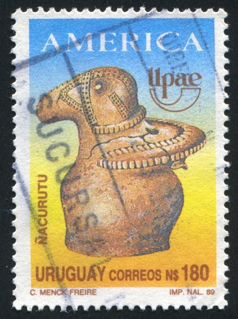 URUGUAY - CIRCA 1989: stamp printed by Uruguay, shows America Issue, Nacurutu Artifact and UPAE Emblem, circa 1989のeditorial素材