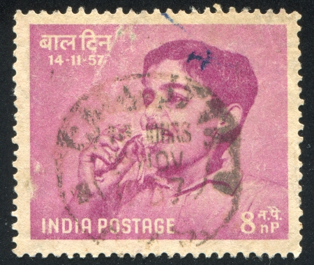 INDIA - CIRCA 1957: stamp printed by India, shows Boy Eating Banana, circa 1957のeditorial素材