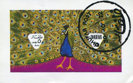 DHUFAR - CIRCA 1972: stamp printed by Dhufar, shows peacock, circa 1972のeditorial素材