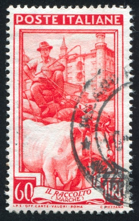 ITALY - CIRCA 1950: stamp printed by Italy, shows Grain cart, circa 1950のeditorial素材