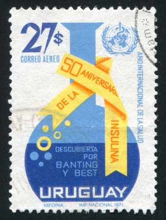 URUGUAY - CIRCA 1972: stamp printed by Uruguay, shows Retort and WHO Emblem, circa 1972のeditorial素材