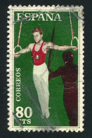 SPAIN - CIRCA 1960: stamp printed by Spain, shows Athlete with rings, circa 1960のeditorial素材