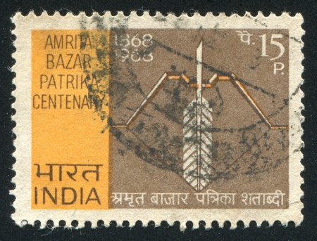 INDIA - CIRCA 1968: stamp printed by India, shows Symbolic Bow and Quill Pen, circa 1968のeditorial素材