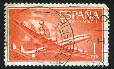 SPAIN - CIRCA 1955: stamp printed by Spain, shows plane and ship, circa 1955のeditorial素材