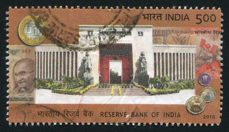 INDIA - CIRCA 2010: stamp printed by India, shows Reserve bank of India, statues, coins, Mahatma Gandhi, circa 2010のeditorial素材