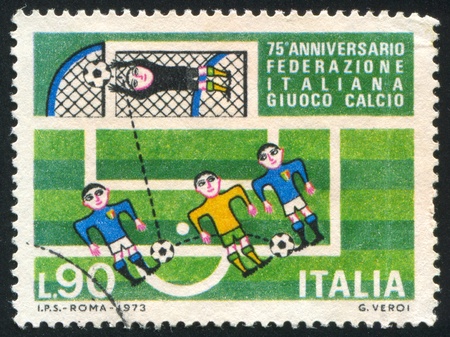 ITALY - CIRCA 1973: stamp printed by Italy, shows Soccer players and goal, circa 1973のeditorial素材