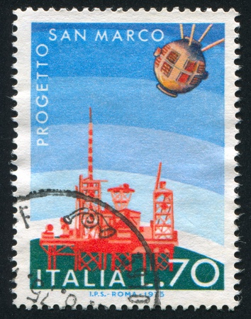 ITALY - CIRCA 1975: stamp printed by Italy, shows Satellite and San Rita launching platform, circa 1975のeditorial素材