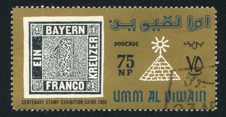 UMM AL-QUWAIN - CIRCA 1966: stamp printed by Umm al-Quwain, shows Stamp and Pyramid, circa 1966のeditorial素材