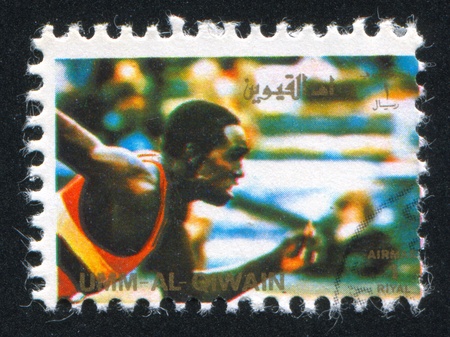 UMM AL-QUWAIN - CIRCA 1972: stamp printed by Umm al-Quwain, shows a Runner, circa 1972のeditorial素材