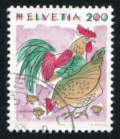 SWITZERLAND - CIRCA 1994: stamp printed by Switzerland, shows Chickens, Animals, circa 1994のeditorial素材