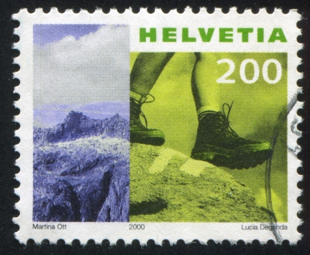 SWITZERLAND - CIRCA 2000: stamp printed by Switzerland, shows Mountain, hiker, circa 2000のeditorial素材