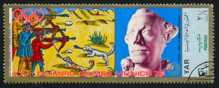YEMEN - CIRCA 1972: stamp printed by Yemen, shows Bow and Arrow Shooting by Magnus and a Statue, circa 1972のeditorial素材