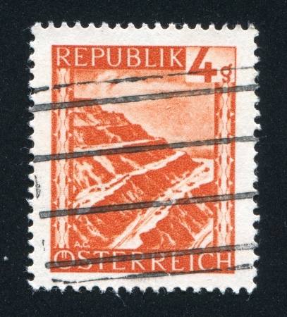 AUSTRIA - CIRCA 1945: stamp printed by Austria, shows Eisenerz surface mine, circa 1945のeditorial素材