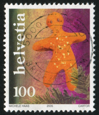 SWITZERLAND - CIRCA 2005: stamp printed by Switzerland, shows Gingerbread man, circa 2005のeditorial素材