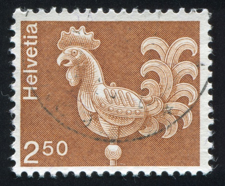 SWITZERLAND - CIRCA 1973: stamp printed by Switzerland, shows Cock Weather Vane, St. Ursus Cathedral, Solothurn, circa 1973のeditorial素材