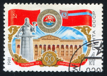 RUSSIA - CIRCA 1984: stamp printed by Russia, shows Georgian Soviet Socialist Republik flags and arms, circa 1984のeditorial素材