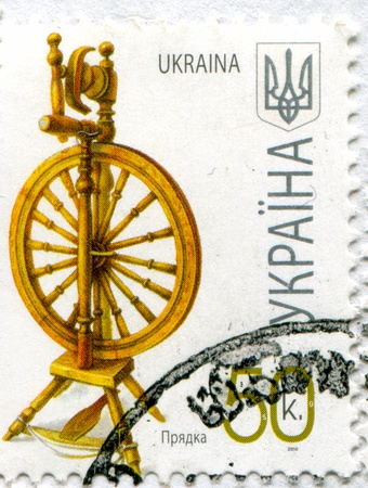 UKRAINE - CIRCA 2010: stamp printed by Ukraine, shows Spinning wheel, circa 2010のeditorial素材
