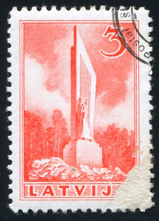 LATVIA - CIRCA 1937: stamp printed by Latvia, shows Independence Monument, Rauna (Ronneburg), circa 1937のeditorial素材