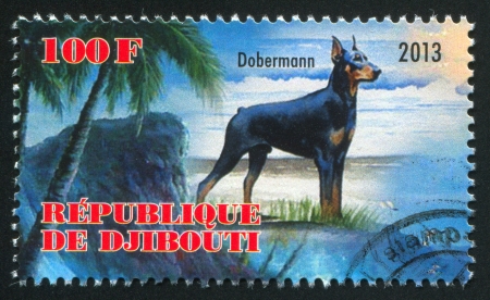 DJIBOUTI - CIRCA 2013: stamp printed by Djibouti, shows Dobermann dog, circa 2013のeditorial素材