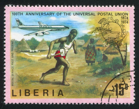 LIBERIA - CIRCA 1974: stamp printed by Liberia, shows Mail runner and jet, circa 1974のeditorial素材