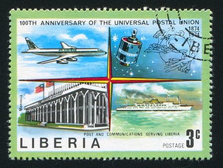 LIBERIA - CIRCA 1974: stamp printed by Liberia, shows Jet, satellite, Post office in Monrovia and ship, circa 1974のeditorial素材